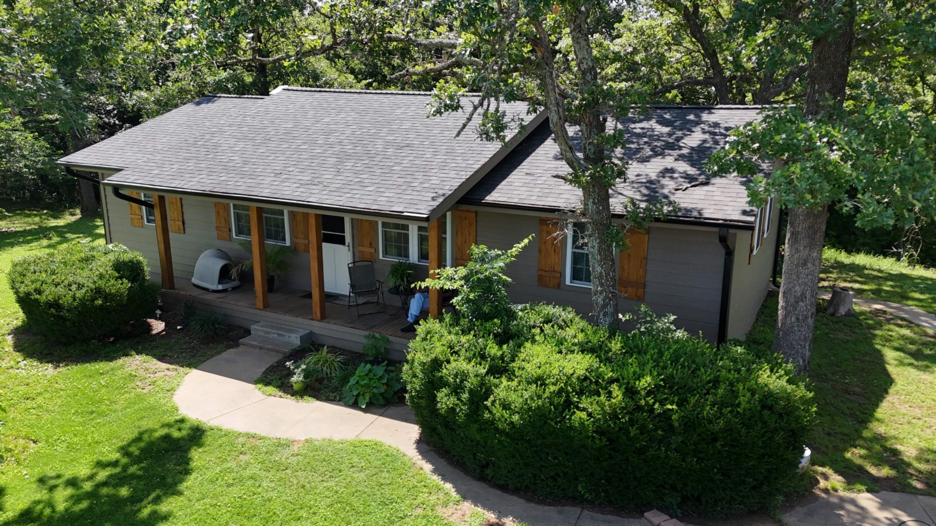 Same Oklahoma home after Top Priority installed a new roof, siding, and cedar shutters
