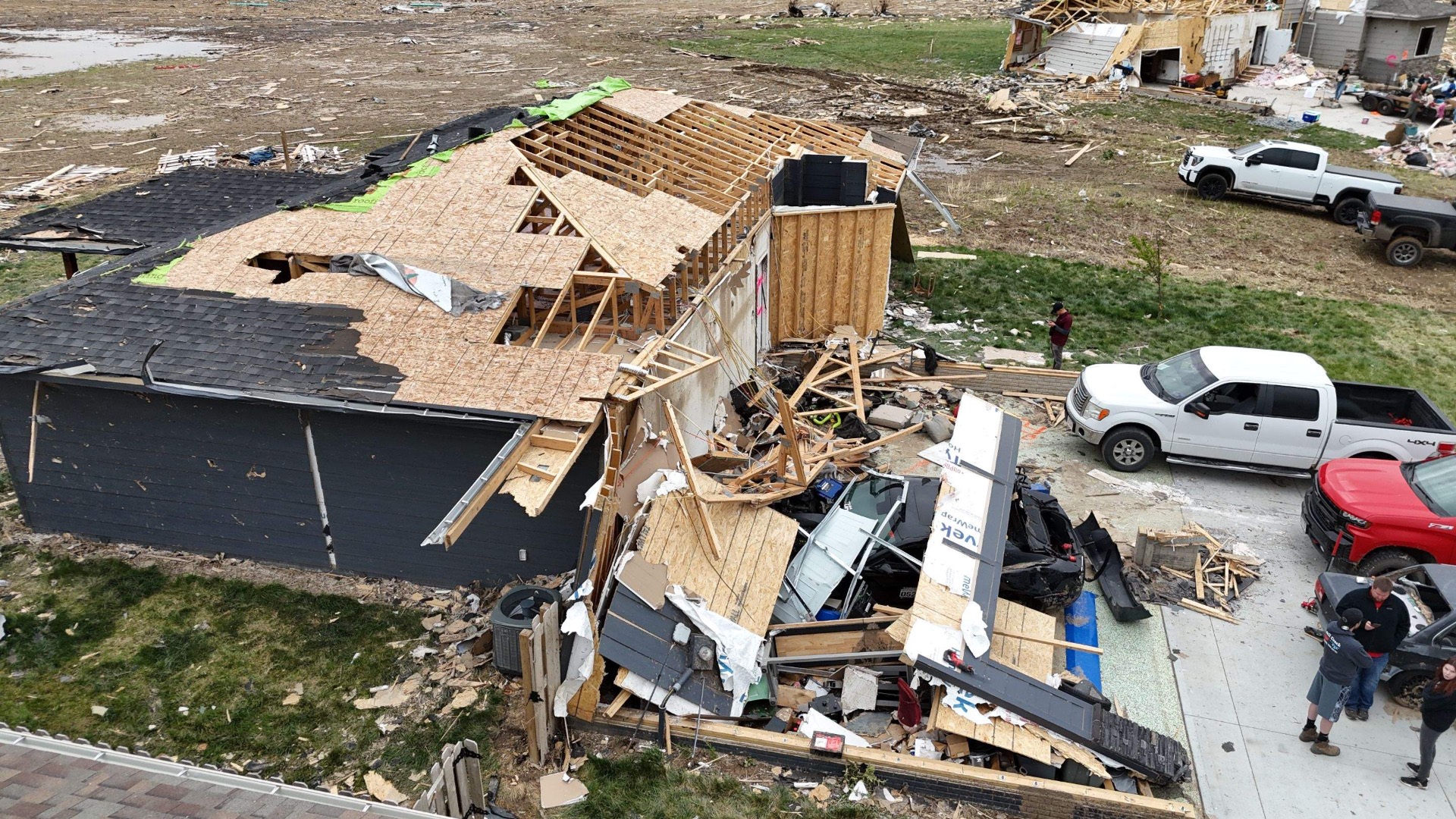 Tornado-damaged Oklahoma home with roof torn open and debris field, on-site Top Priority assessment