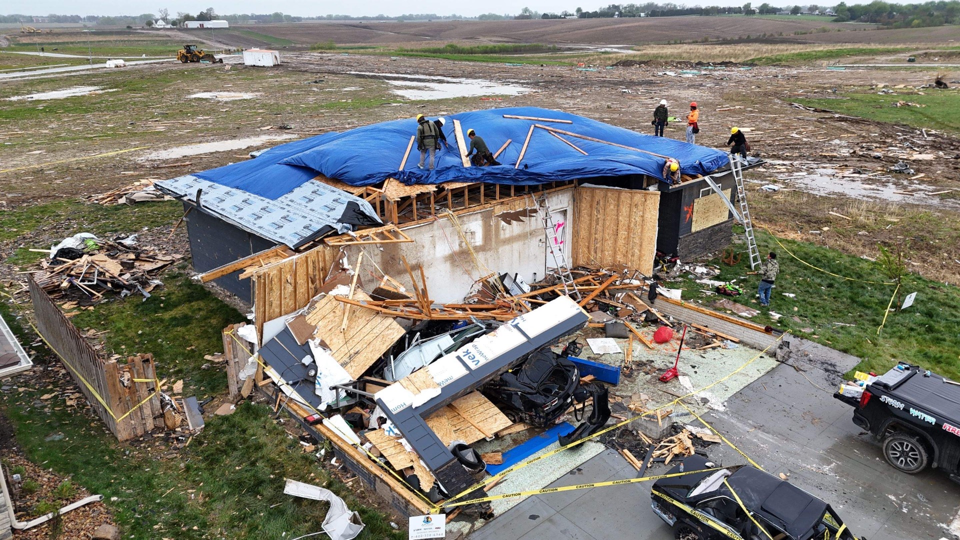 Top Priority crew installing emergency tarp on a tornado-damaged roof to prevent further water damage